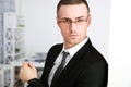 Confident businessman in glasses at office