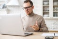 Confident businessman with glasses sitting at desk, making conference video call Royalty Free Stock Photo