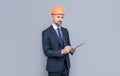 confident businessman in helmet hold folder. safety business expertise. man in hardhat making notes. Royalty Free Stock Photo