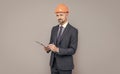 confident businessman in helmet hold folder. safety business expertise. man in hardhat making notes. Royalty Free Stock Photo