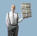 Confident businessman holding a pile of paperwork with one hand