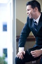 Confident businessman looking out office window Royalty Free Stock Photo