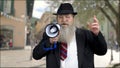 Confident businessman making an announcement through megaphone.