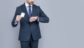 confident businessman man in suit showing debit card cheking time for copy space, fast payment