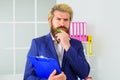 Confident businessman in office. Bearded handsome man with notepad. Pensive Manager at workplace. Royalty Free Stock Photo