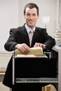 Confident businessman searches through file drawer Royalty Free Stock Photo