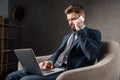 confident businessman sitting in armchair and Royalty Free Stock Photo