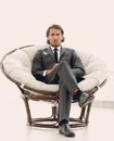 Confident businessman sitting in a large comfortable chair. Royalty Free Stock Photo