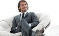 Confident businessman sitting in a large comfortable chair. Royalty Free Stock Photo