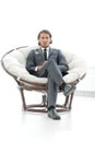 Confident businessman sitting in a large comfortable chair. Royalty Free Stock Photo