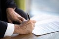 Close up male hands puts his signature on official document Royalty Free Stock Photo
