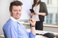 Confident Businessman Smiling While Colleague Holding Tablet Com Royalty Free Stock Photo