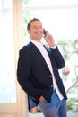 Confident businessman smiling with mobile phone Royalty Free Stock Photo