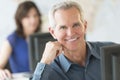 Confident Businessman Smiling In Office Royalty Free Stock Photo