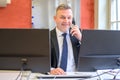 Confident businessman talking on a phone in an office Royalty Free Stock Photo