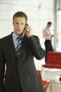 Confident Businessman Using Cellphone In Office Royalty Free Stock Photo