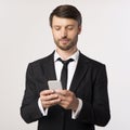 Confident Businessman Using Cellphone Texting Over White Background Royalty Free Stock Photo