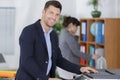 Confident businessman using printer in office Royalty Free Stock Photo