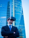 Confident businessman using virtual reality glasses in a business center Royalty Free Stock Photo