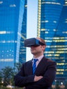 Confident businessman using virtual reality glasses in a business center Royalty Free Stock Photo