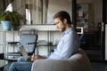 Confident businessman working with documents on laptop at modern office Royalty Free Stock Photo