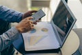 Confident businessman working on laptop, tablet and smartphone in her workplace at office corporate communication Royalty Free Stock Photo