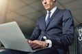 Confident businessman works with his gray notebook