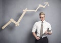 Confident businessman with wrench and graph. Royalty Free Stock Photo