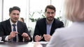 Confident businessmen talk with client at business meeting