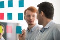 Confident businessmen working together using colourful post-it notes Royalty Free Stock Photo