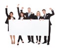 Confident businesspeople holding blank banner