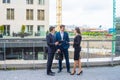 Confident businesspersons talking in front of modern office building. Businessman and businesswoman have business Royalty Free Stock Photo