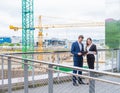 Confident businesspersons talking in front of modern office building. Businessman and businesswoman have business Royalty Free Stock Photo