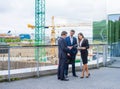 Confident businesspersons talking in front of modern office building. Businessman and businesswoman have business Royalty Free Stock Photo