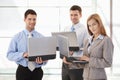 Confident businessteam working on laptop smiling Royalty Free Stock Photo