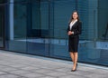 Confident businesswoman in front of modern office building. Business, banking, corporation and financial market concept. Royalty Free Stock Photo