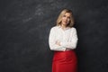 Serious businesswoman at gray studio background