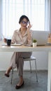 Confident businesswoman holding her glasses and working with computer laptop at modern office. Royalty Free Stock Photo