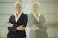 Confident Businesswoman Leaning Against Glass Partition