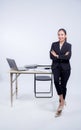 Confident businesswoman in office smiling at the camera with folded arms in office. Royalty Free Stock Photo