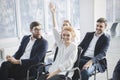 Confident businesswoman raising hand to ask question at seminar Royalty Free Stock Photo