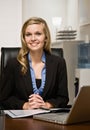 Confident businesswoman reading report at desk Royalty Free Stock Photo