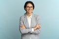 Confident businesswoman, smiling, looking at camera standing with crossed arms isolated in studio. Royalty Free Stock Photo