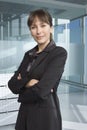 Confident Businesswoman Standing Arms Crossed In Office Royalty Free Stock Photo