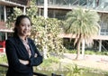 confident businesswoman standing with arms crossed outside office building. young female entrepreneur woman smiling outdoors. Royalty Free Stock Photo