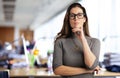 Confident businesswoman standing in a modern office and wearing casual clothes Royalty Free Stock Photo