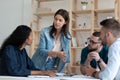 Confident businesswoman team leader speaking, training staff at meeting Royalty Free Stock Photo