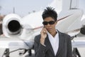 Confident Businesswoman Using Cellphone At Airfield Royalty Free Stock Photo