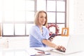 Confident businesswoman using her notebook and text messaging while working in the office Royalty Free Stock Photo