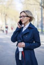 Businesswoman using smart phone on the street Royalty Free Stock Photo